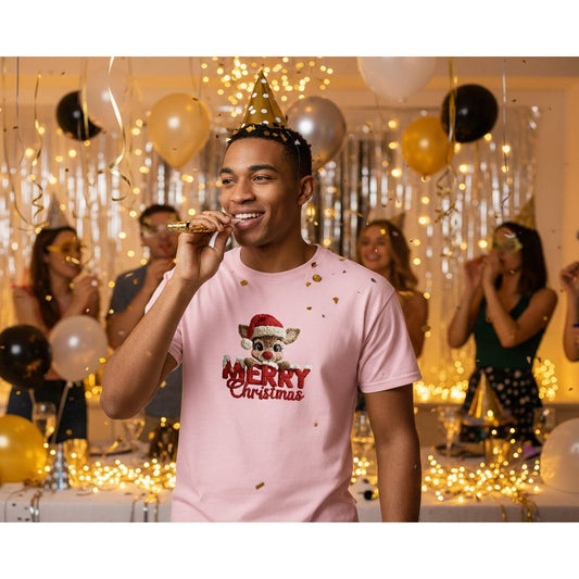 Man wearing a pink 'Merry Christmas' t-shirt at a festive party with balloons and decorations.