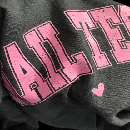 Black sweatshirt with pink 'ALWAYS' text and a heart on a dark background